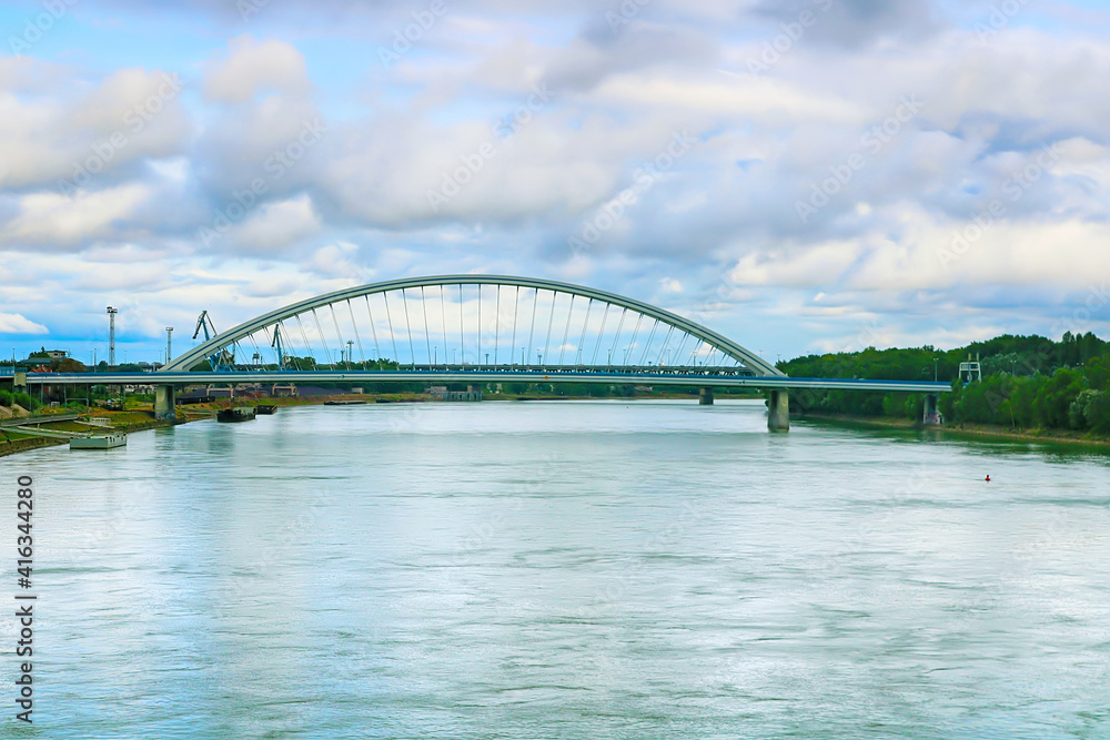 Fototapeta premium Modern arched Apollo bridge and Danube river in Bratislava, Slovakia