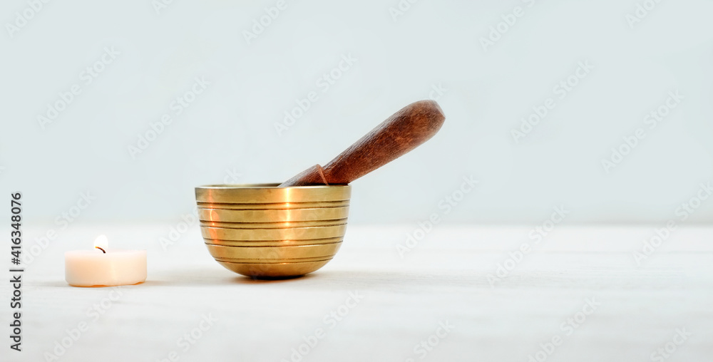 Tibetian singing bowl with candle on white wooden background, sound therapy. Copy space Tibetian singing bowl with candle on white wooden background, sound therapy. Copy space