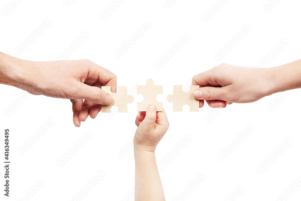 Three hands are holding puzzles on a white background. Help of a psychologist in family problems.