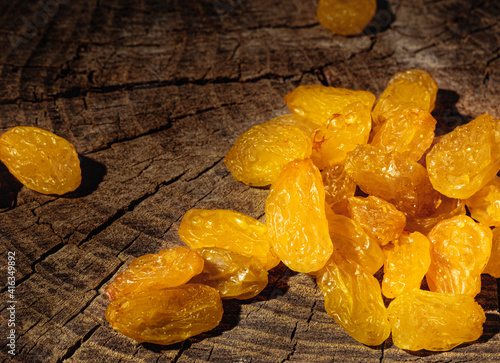 Raisins on dark wooden background