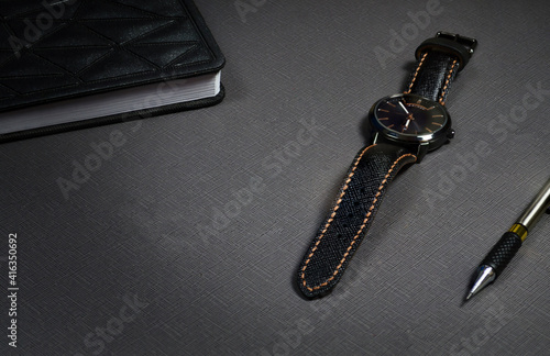mechanical men's black watch with a black strap made of genuine saffiano leather stitched with brown threads, handmade, with a notebook and a pen, place for text