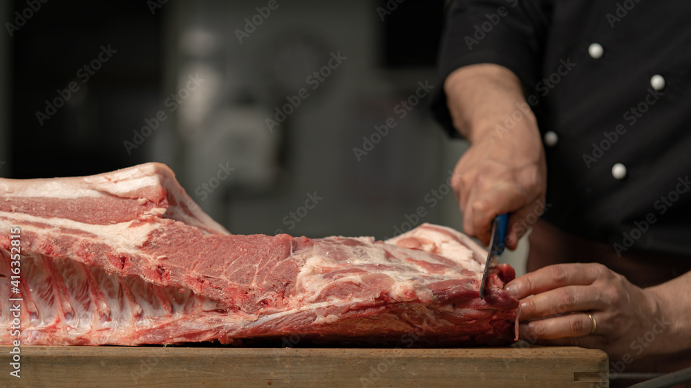 butcher processes the meat in the butchery