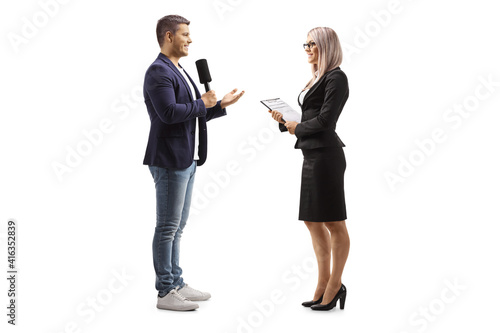 Obraz na plátně Full length profile shot of a male reporter interviewing a businesswoman