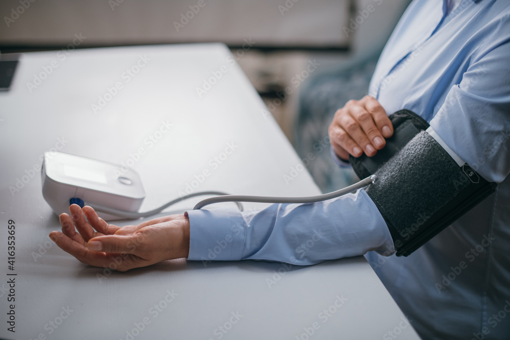 Hands with a tonometer on the table Hands with a tonometer on the table