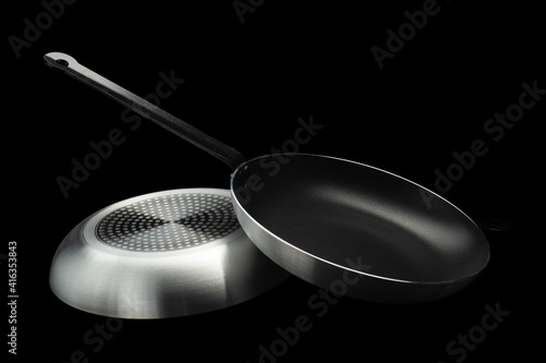 Obraz na płótnie frying pan on both sides on a black background