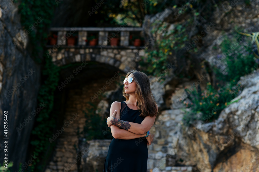 Girl in black dress and glasses posing Girl in black dress and glasses posing