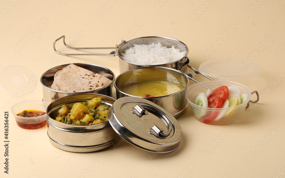 Typical Stainless steel Lunch Box or Tiffin with Maharashtrian food menu Chapati OR Roti, Plain Dal Tadka, White Rice Potato sabji with salad and pickle Typical Stainless steel Lunch Box or Tiffin with Maharashtrian food menu Chapati OR Roti, Plain Dal Tadka, White Rice Potato sabji with salad and pickle