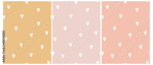 Cute Hand Drawn Irregular Romantic Seamless Vector Pattern. White  Hearts Isolated on a Light Pink, Pale Yellow and Sweet Pink Background. Funny Infantile Repeatable Print.