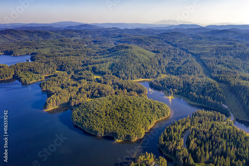 Amazing aerial view from drone of a beautiful panorama of blue water and green forest.