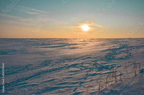 Snow-covered expanses in the rays of the setting sun