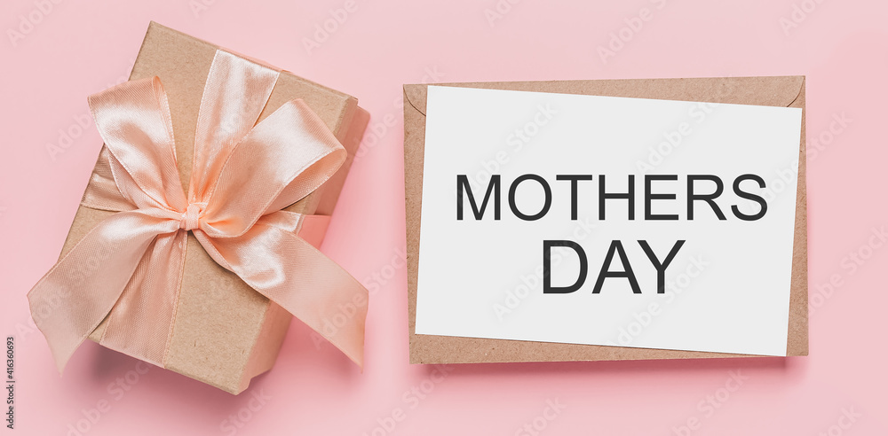 Gifts with note letter on isolated pink background, love and valentine concept with text mothers Day Gifts with note letter on isolated pink background, love and valentine concept with text mothers Day