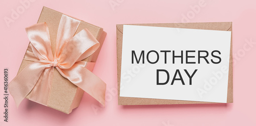 Gifts with note letter on isolated pink background, love and valentine concept with text mothers Day
