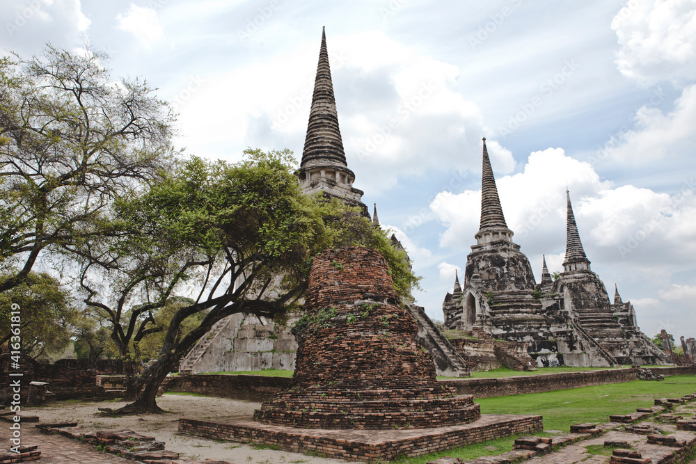 Fototapeta premium AYUTTHAYA, THAILAND - MAY 25, 2018: Ayutthaya Historical Park in Ayutthaya (second capital of the Siamese Kingdom). A very popular destination for day trips from Bangkok. Wat Phrasisanpetch Temple. 
