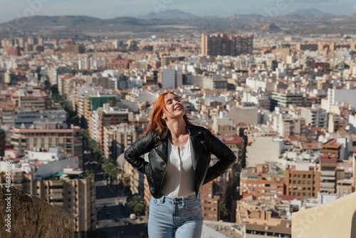 beautiful Happy Woman enjoys the views of the City