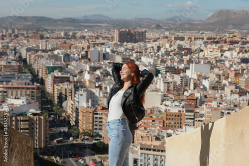 beautiful Happy Woman enjoys the views of the City