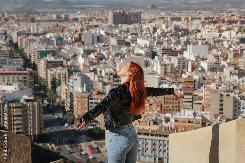 beautiful Happy Woman enjoys the views of the City