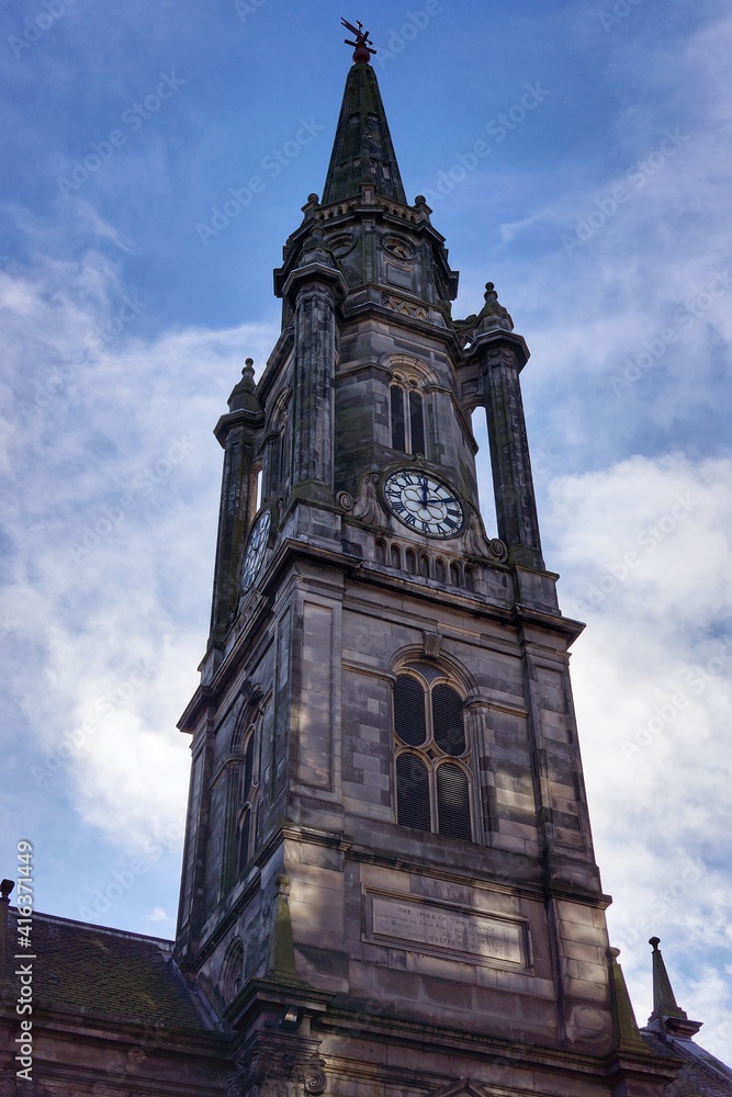 Close up view of the spire of Tron Kirk in the morning at the Royal Mile in Edinburgh, UK. Clear blue sky. Close up view of the spire of Tron Kirk in the morning at the Royal Mile in Edinburgh, UK. Clear blue sky.