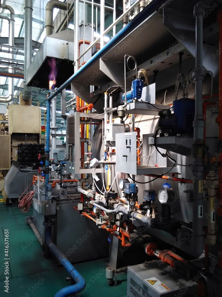 View of automatic mechanical instruments in modern production plant manufacturing process. For modern industrial, machinery, engineering and safety background. View of automatic mechanical instruments in modern production plant manufacturing process. For modern industrial, machinery, engineering and safety background.
