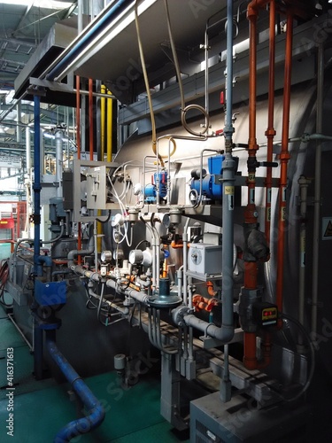 View of automatic mechanical instruments in production plant manufacturing process. For modern industrial, machinery, engineering and safety background.