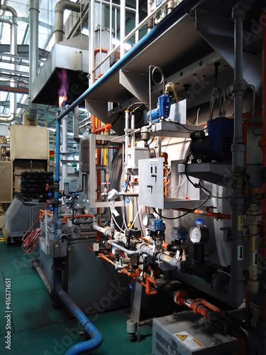 View of automatic mechanical instruments in modern production plant manufacturing process. For modern industrial, machinery, engineering and safety background.