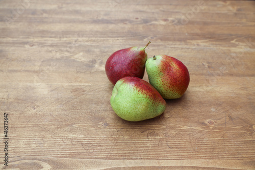 green pear with pink on a wooden table 