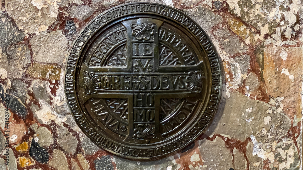 Ancient catholic symbol on tomb wall