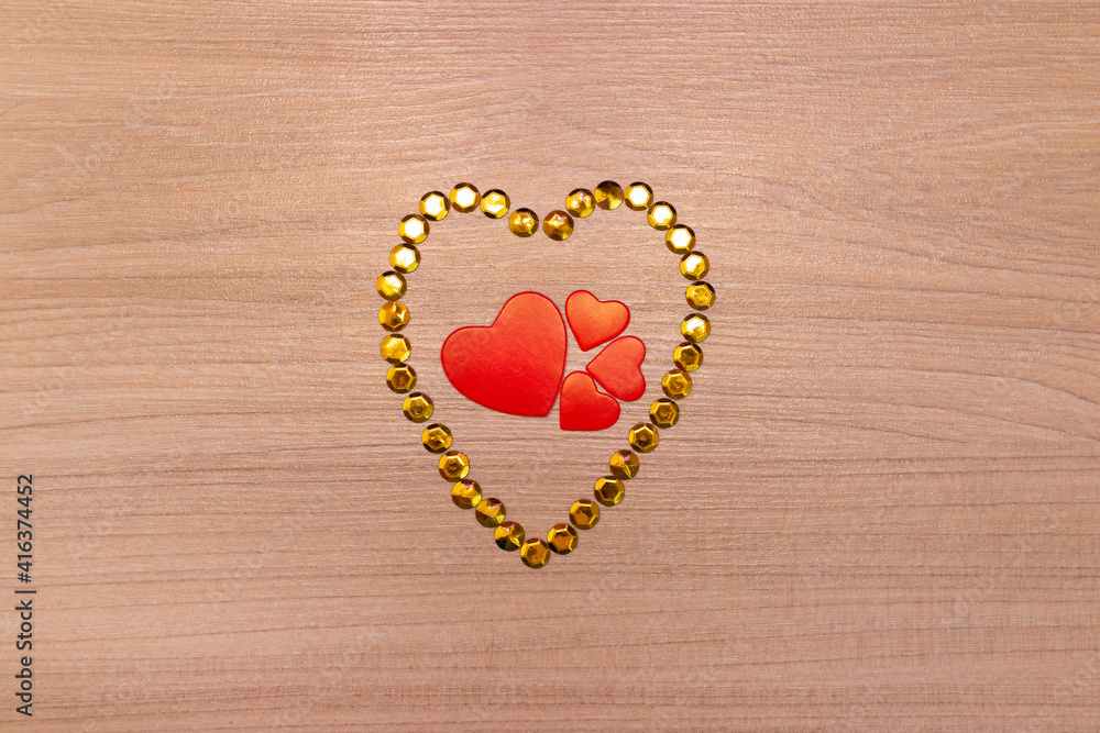 Hearts on wooden background with yellow sparkles. Valentine's Day or Mother's Day greeting card. Hearts on wooden background with yellow sparkles. Valentine's Day or Mother's Day greeting card.