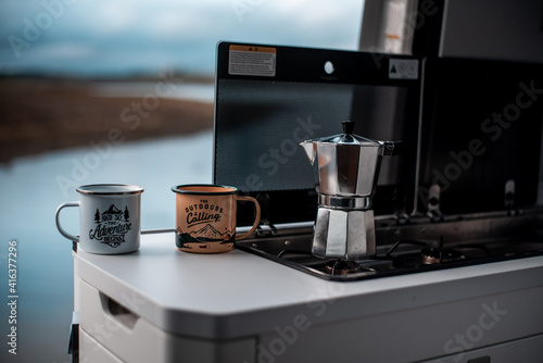 Cups of coffee in the kitchen of a motorhome, campervan and road life traveling concept