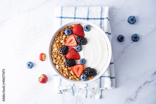 Fresh breakfast with greek yogurt nuts oatmeal granola with berries in a bowl