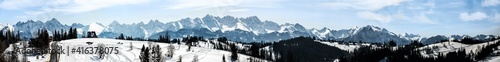 Extra wide panorama of Tatra mountains in winter viewed from Bukowina Tatrzanska in Poland. Good for a banner.