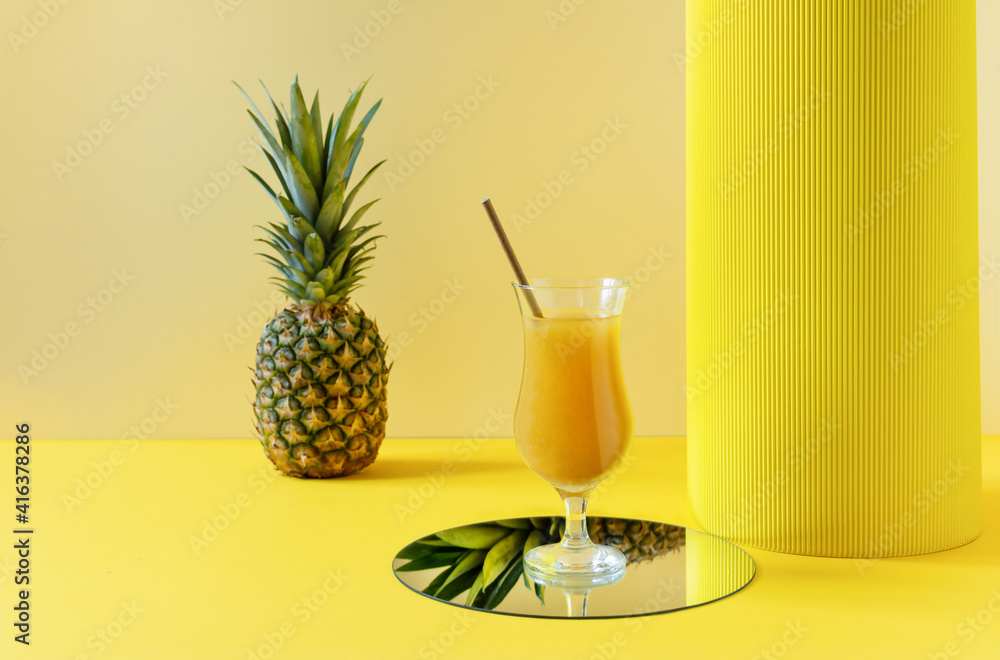 Pineapple fresh juice in glass on yellow background. Pineapple fresh juice in glass on yellow background.