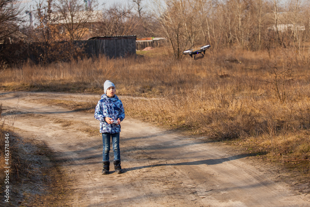 Boy launching his drone in spring Boy launching his drone in spring