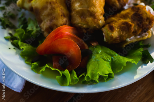 fried pancake with fish and vegetables