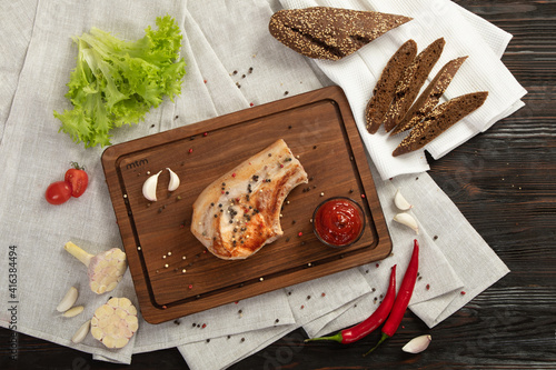 Fried pork entrecote on a board for serving.