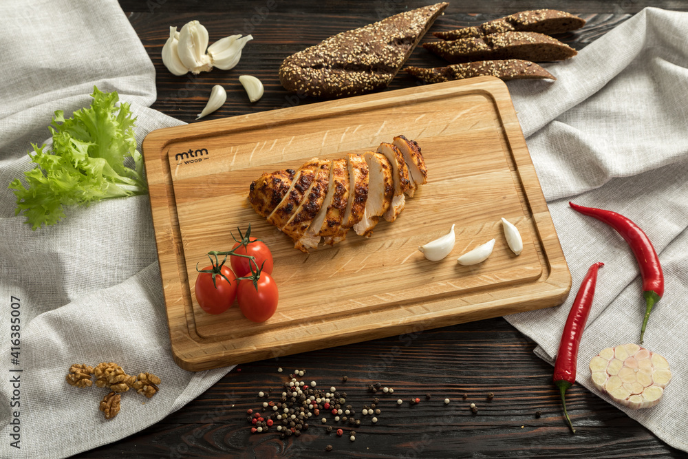sliced chicken breast on wooden cutting board