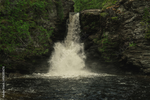 Waterfall flushing down a slate rock wall