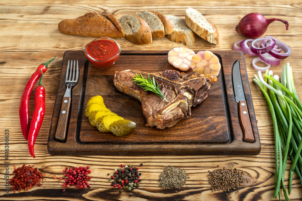 Roasted beef on the bone on a board for serving.