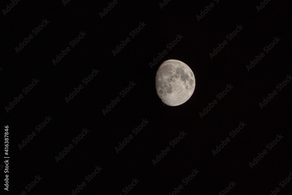 three quarters of the moon in the night sky three quarters of the moon in the night sky
