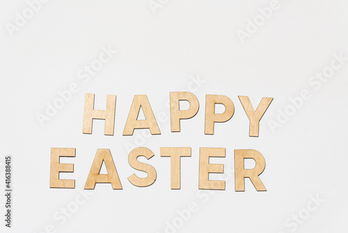 Happy easter. Wooden letter on background