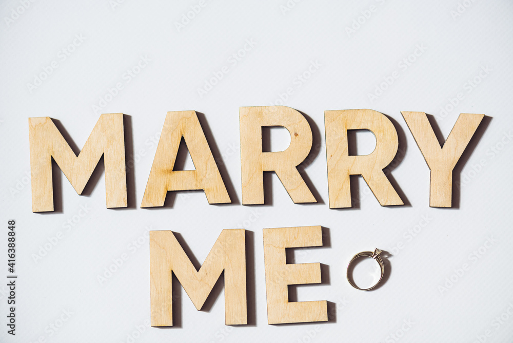 Alphabet letter wooden letters with words Marry me. Marriage proposal and love concept for Valentine`s day with wedding or engagement Alphabet letter wooden letters with words Marry me. Marriage proposal and love concept for Valentine`s day with wedding or engagement