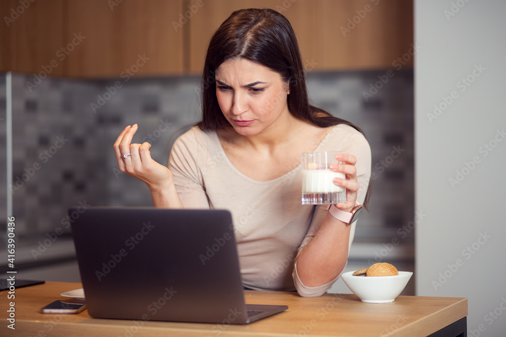 Woman eat breakfast and using laptop at morning Woman eat breakfast and using laptop at morning