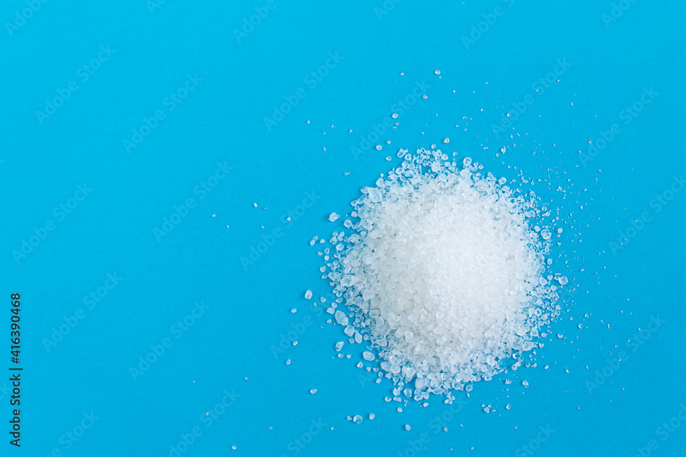 Dead Sea salt crystals on a blue background close-up, top view. Dead Sea salt crystals on a blue background close-up, top view.