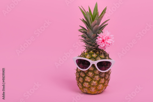  Female pineapple hipster in sunglasses with flower, stylish fruit, minimal concept