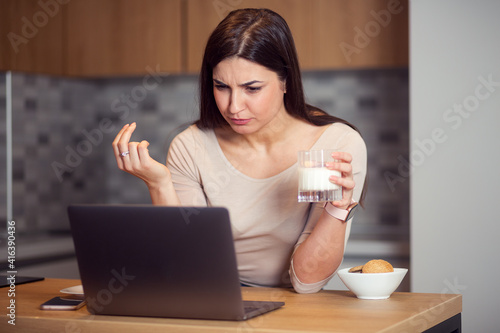 Woman eat breakfast and using laptop at morning