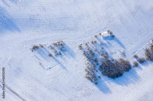 Beautiful aerial view of the huge frozen lake in the middle of a forest in Latvia. Frozen Ungurs lake in Latvia. photo