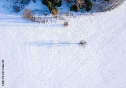 Beautiful aerial view of the huge frozen lake in the middle of a forest in Latvia. Frozen Ungurs lake in Latvia. photo