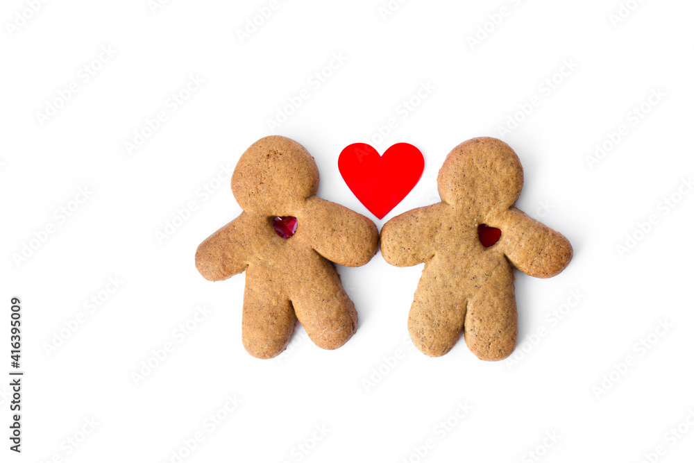 A pair of gingerbread lovers with hearts isolated on a white background. Christmas cookies with love. A pair of gingerbread lovers with hearts isolated on a white background. Christmas cookies with love.