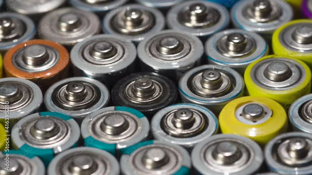Preparing Bbatteries for Recycling. Dense array of AA batteries moving with slight rotation close-up Preparing Bbatteries for Recycling. Dense array of AA batteries moving with slight rotation close-up