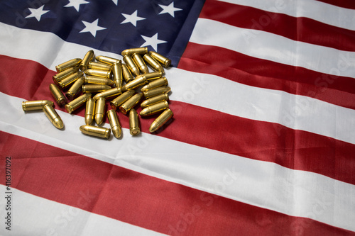 Fototapeta Naklejka Na Ścianę i Meble -  Closeup of a group of 9mm pistol ammunition on the American flag. Gun laws in the USA. weapon ammo.