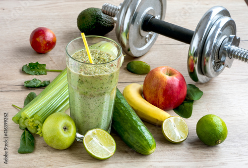 Green spinach and celery smoothie. The beginning of healthy habits and a healthy lifestyle. Chrome dumbbell with healthy food and drink